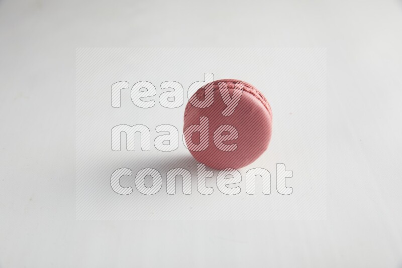 45º Shot of Pink Raspberry macaron on white background