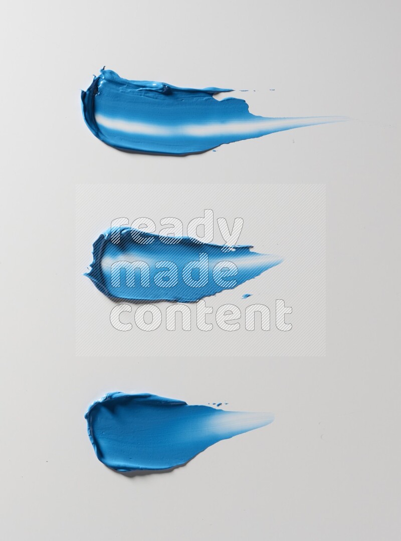 Blue painting knife strokes on white background