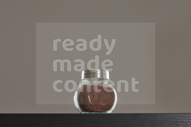 Garden cress in a glass jar on black background