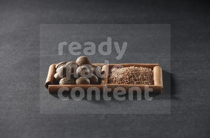 2 squares of cinnamon sticks full of mustard seeds and nutmeg on black flooring