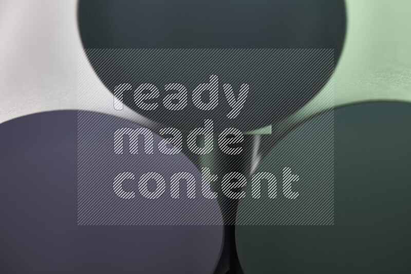 The image shows an abstract paper art with circular shapes in varying shades of green