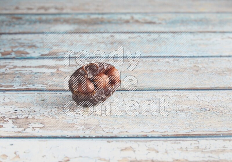 hazelnuts stuffed madjoul date on a light blue wooden background