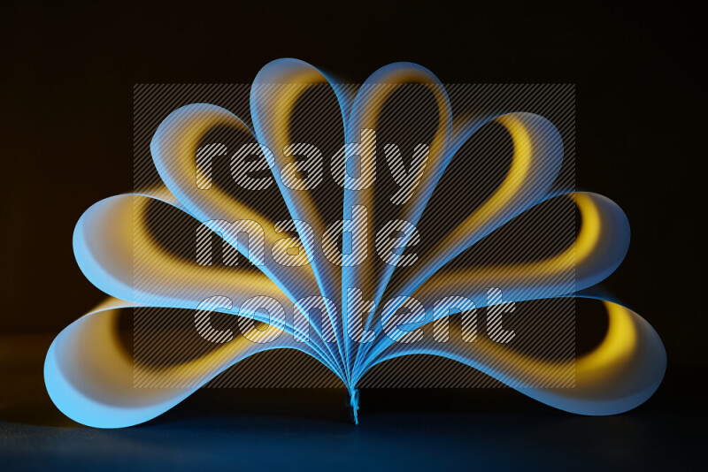 An abstract art piece displaying smooth curves in yellow and blue gradients created by colored light