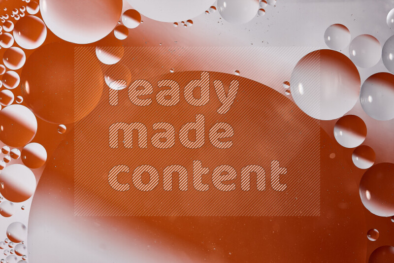 Close-ups of abstract oil bubbles on water surface in shades of white and orange