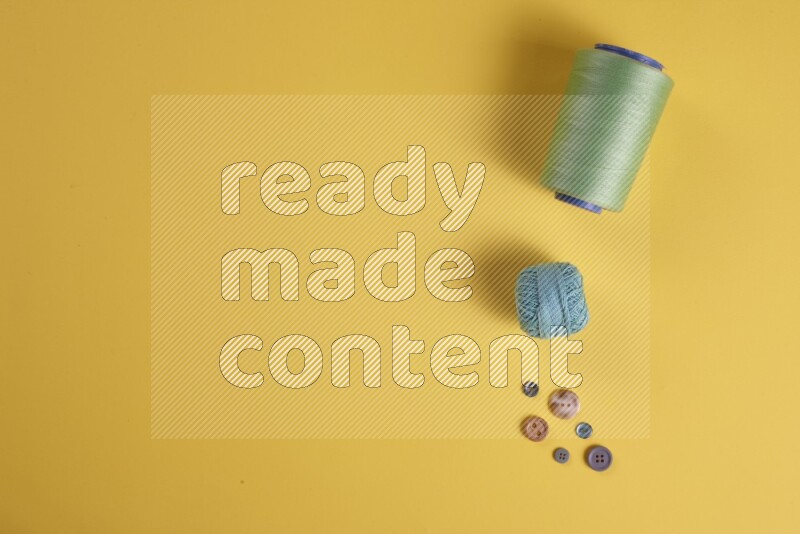 A green collection of sewing and tailoring tools arranged on a yellow background