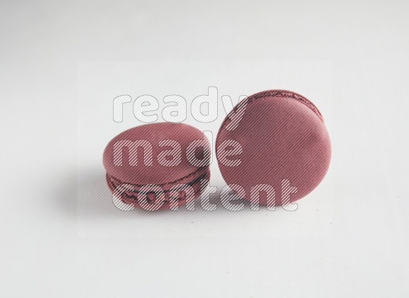 45º Shot of two Red Cherry macarons on white background