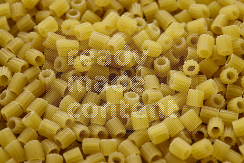 Small rings pasta on grey background