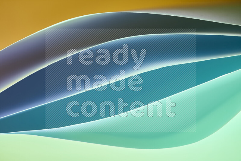 This image showcases an abstract paper art composition with paper curves in green and yellow gradients created by colored light