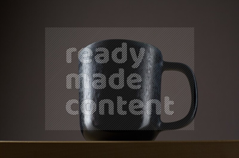 Low angle shot of a black cup on grey background
