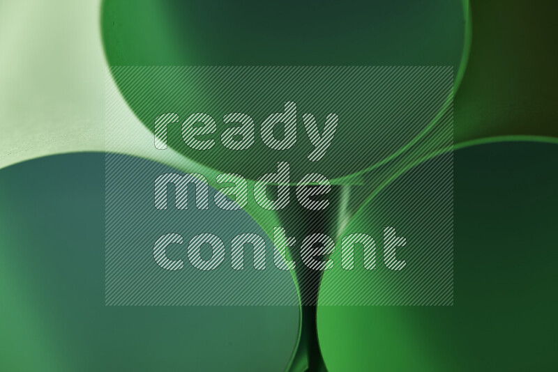 The image shows an abstract paper art with circular shapes in varying shades of green