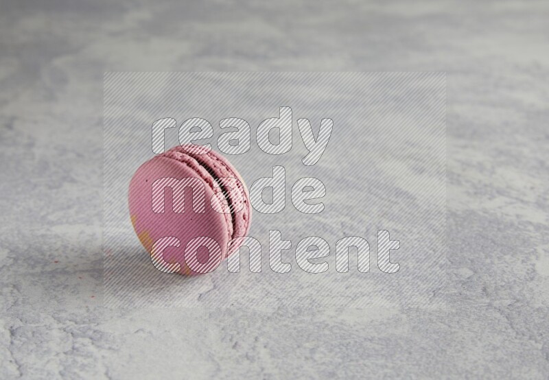 45º Shot of Purple Strawberry macaron on white  marble background