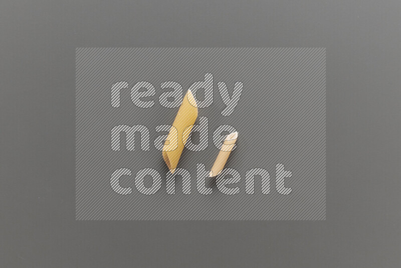 Penne pasta with other types of pasta on grey background