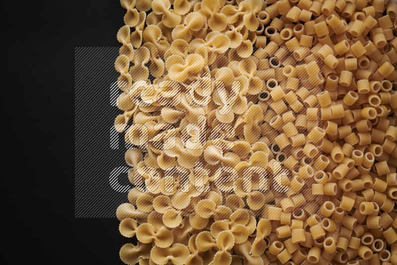 Different pasta types on black background