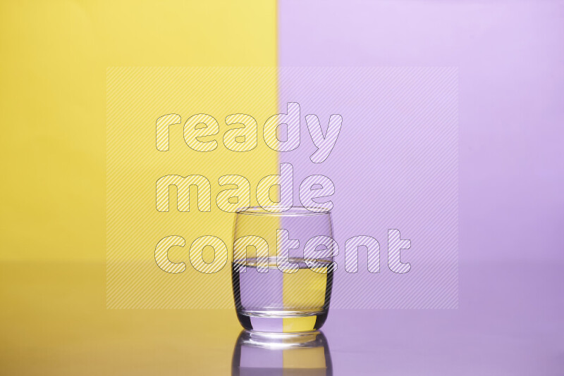 The image features a clear glassware filled with water, set against yellow and light purple background