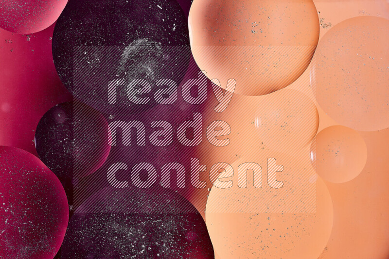 Close-ups of abstract oil bubbles on water surface in shades of red, orange and purple