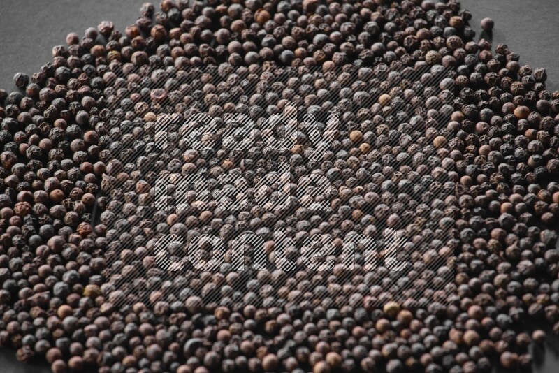Black pepper on a black flooring
