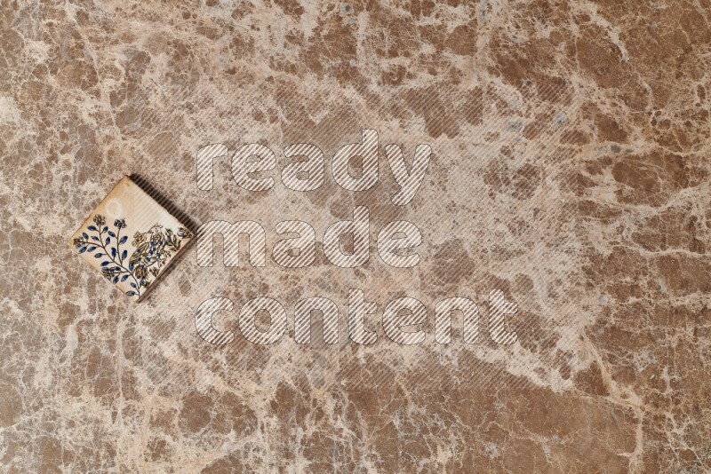 A decorative coaster on beige marble background