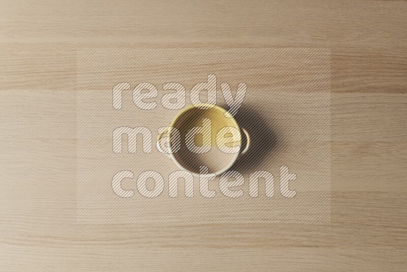 A multicolored pottery oven plate on light wooden background