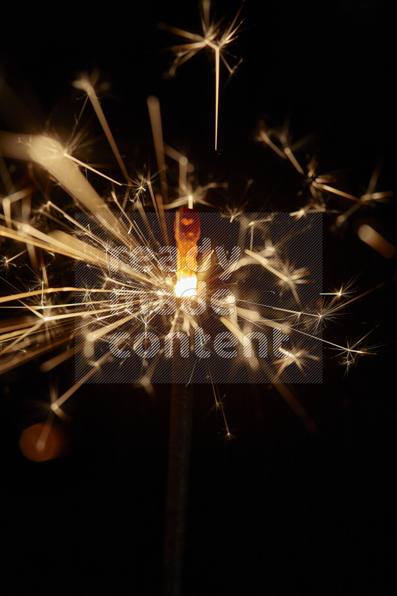 A close-up image of sparkler candle isolated on black background