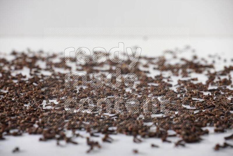 Cloves spread on white flooring