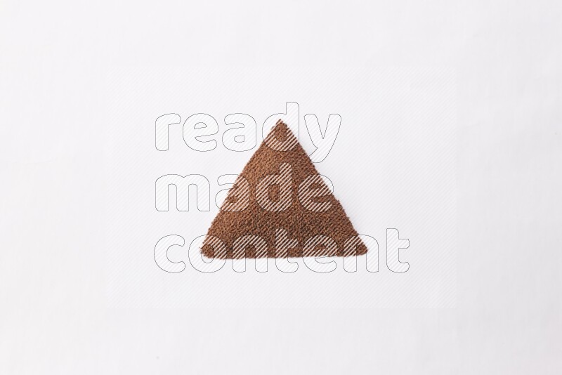 Garden cress seeds in a triangle shape on a white flooring