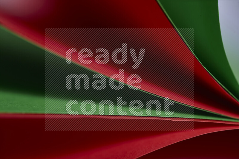 An abstract art showing red and green paper sheets arranged in an overlapping curves