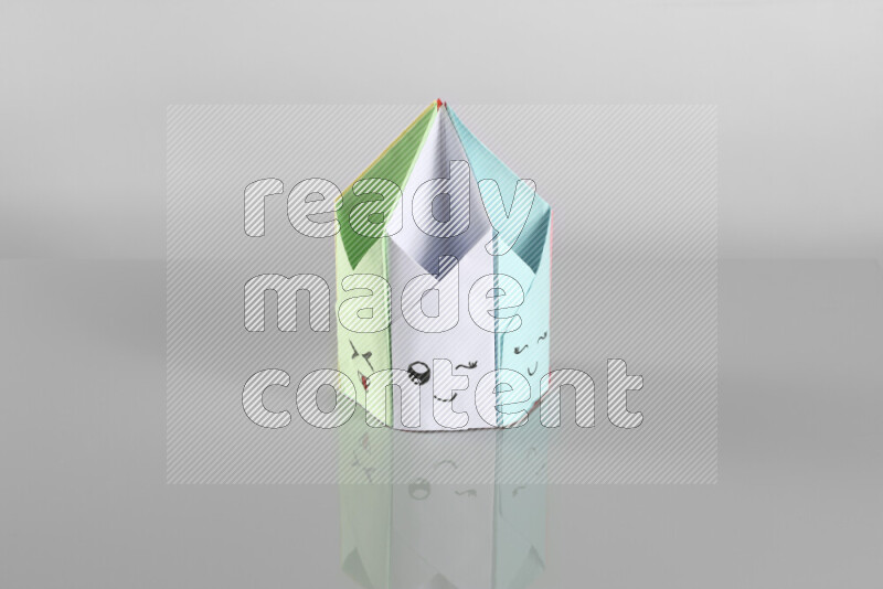 Origami pen holder on grey background