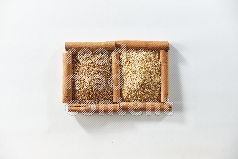 2 squares of cinnamon sticks full of mustard seeds and sesame on white flooring