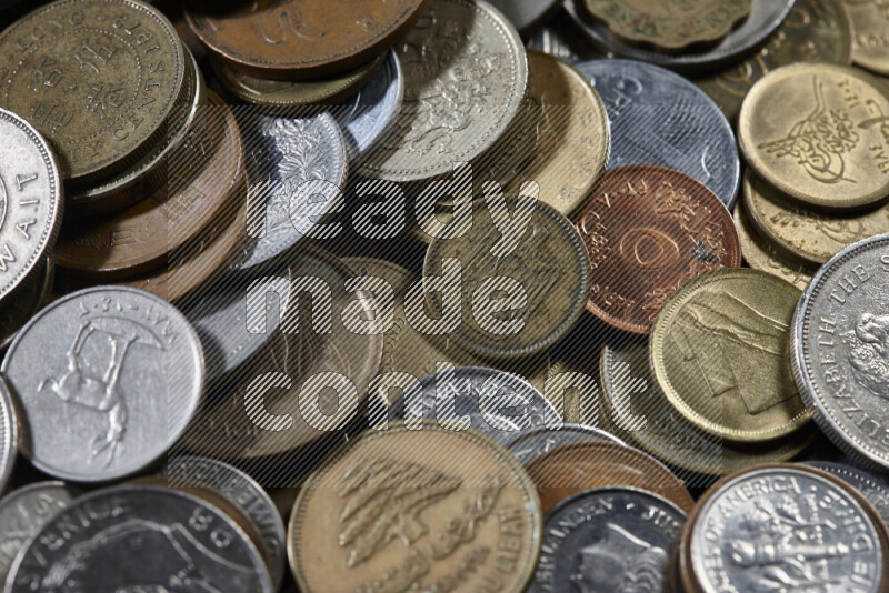 A close-ups of random old coins on black background