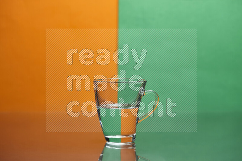 The image features a clear glassware filled with water, set against orange and green background