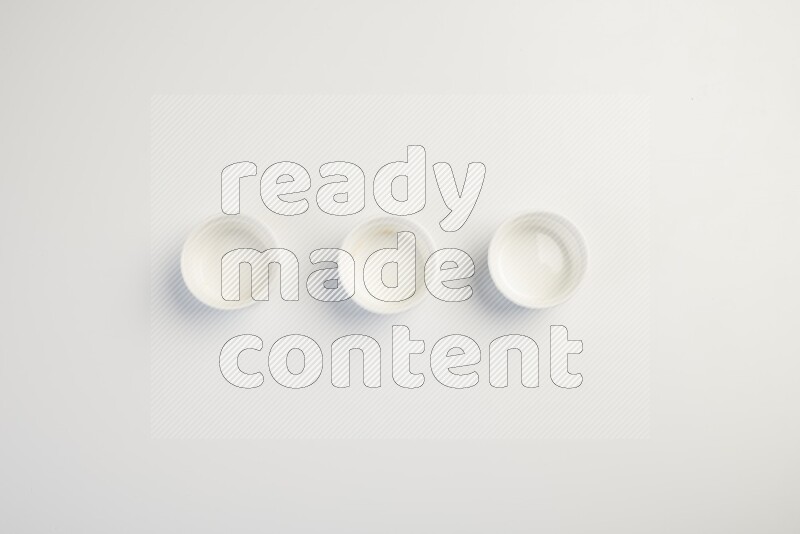 white ceramic round sauce dish on white countertop