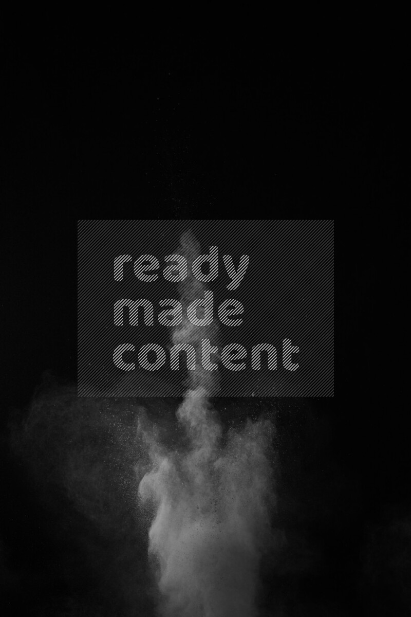 A side view of white powder explosion on black background