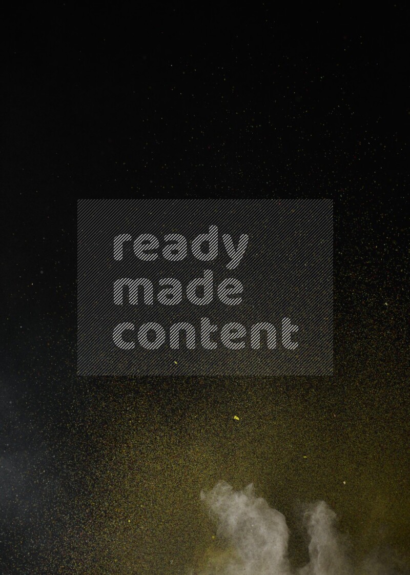 A side view of brown powder explosion on black background