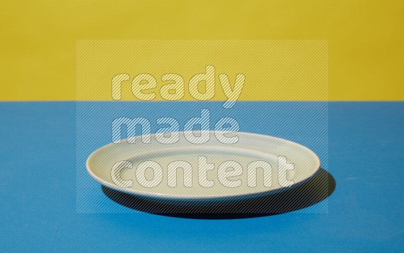 white plate on yellow and blue background