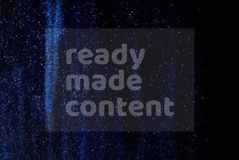 Blue glitter powder isolated on black background
