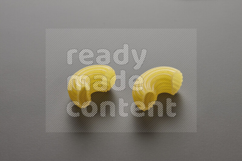 Elbow pasta on grey background