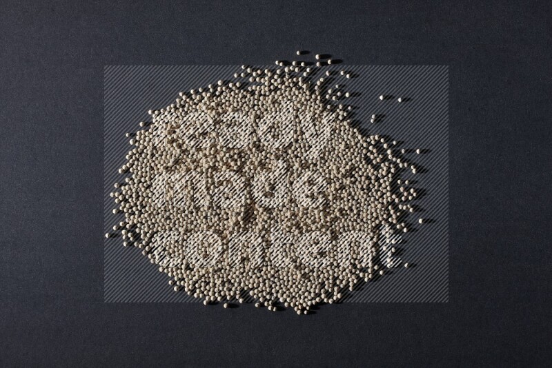 White pepper beads on black flooring