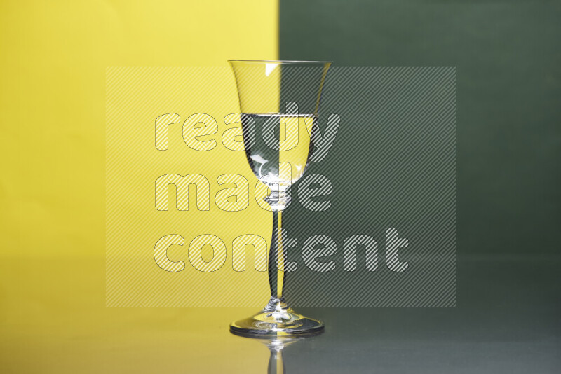 The image features a clear glassware filled with water, set against yellow and dark green background