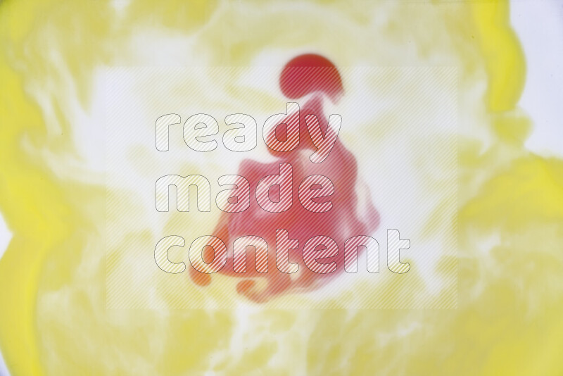 A close-up of abstract swirling patterns in yellow, red and white