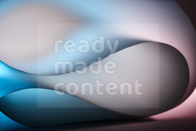 An abstract art piece displaying smooth curves in blue and white gradients created by colored light