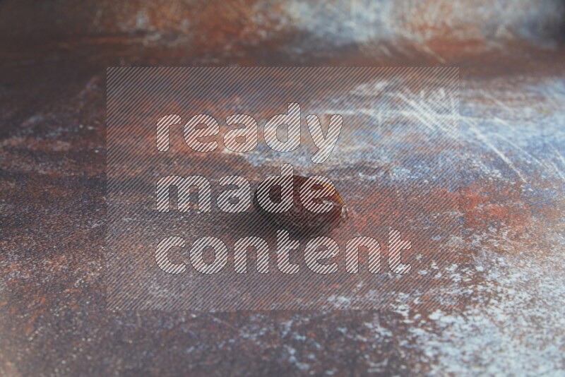 one madjoul date on a rustic reddish background