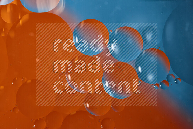 Close-ups of abstract oil bubbles on water surface in shades of blue and orange