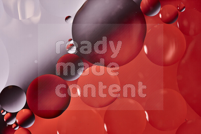 Close-ups of abstract oil bubbles on water surface in shades of white and red