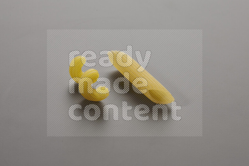 Twist pasta with other types of pasta on grey background