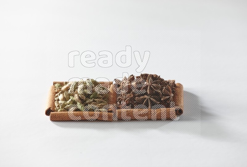 2 squares of cinnamon sticks full of star anise and cardamom on white flooring