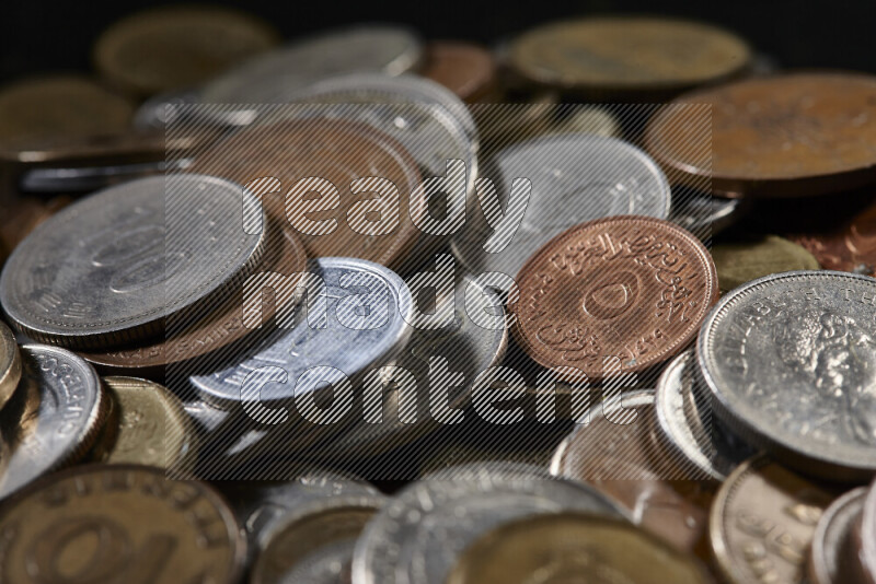 A close-ups of random old coins on black background