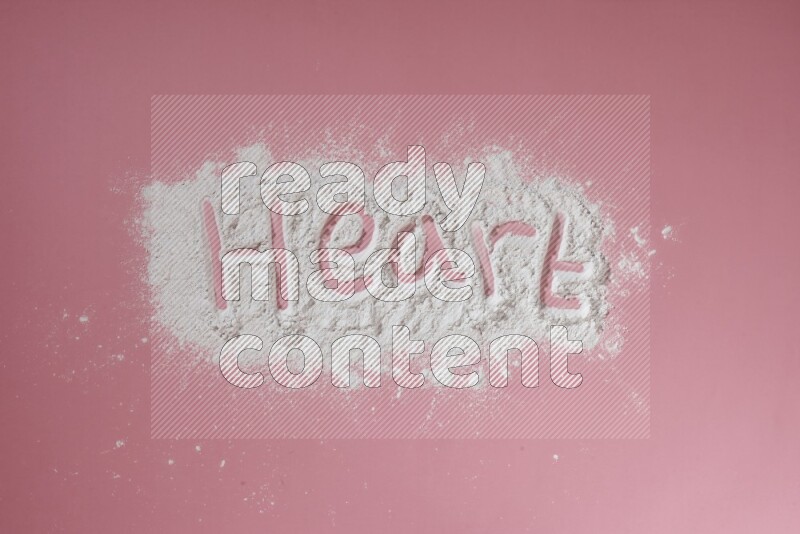 A word written with powder on pink background