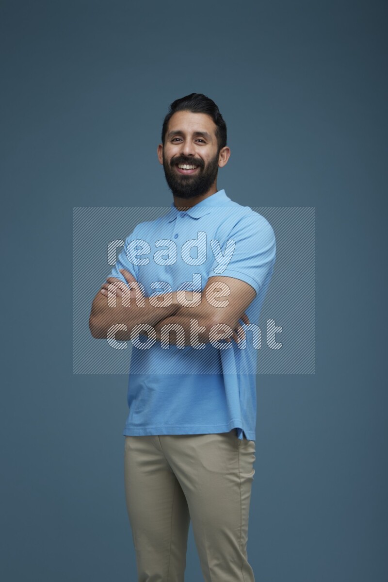 Man posing in a blue background wearing a Blue shirt