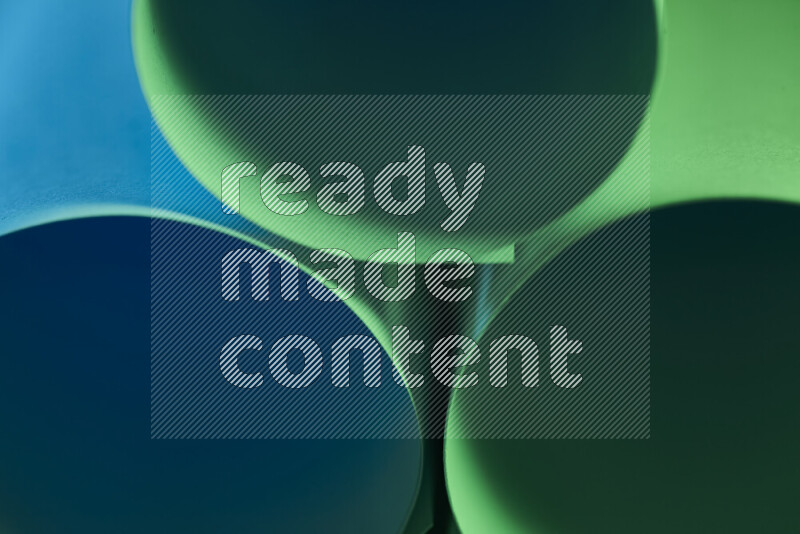The image shows an abstract paper art with circular shapes in varying shades of green and blue