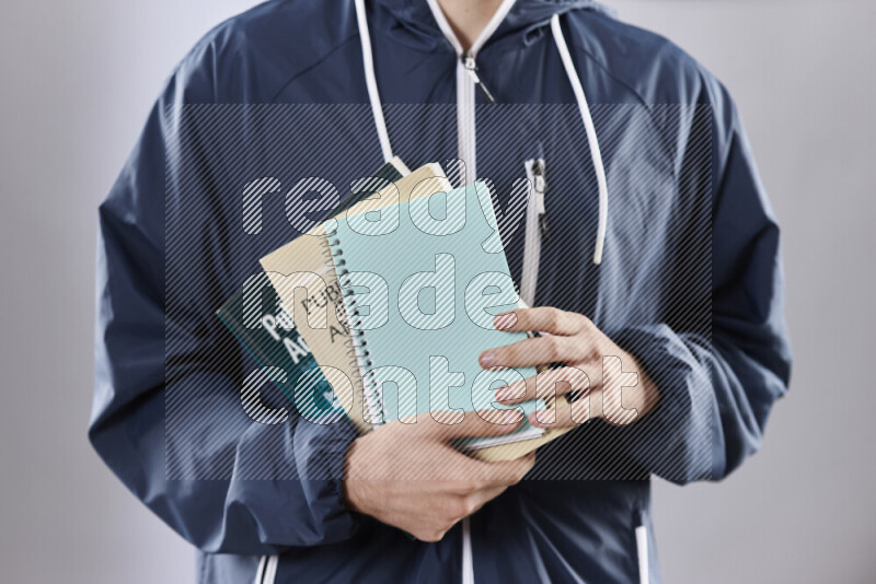 Man holding books and a board in different positions (back to school)